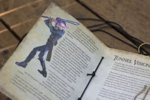 closeup page of a journal with text and a character rendering