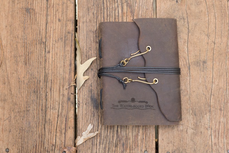 photo of a leather-bound journal on a wood background