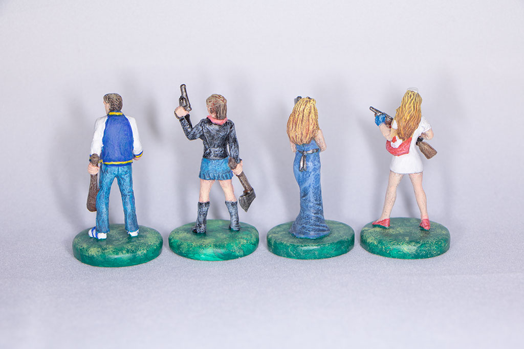 backs of miniature characters from Last Night on Earth